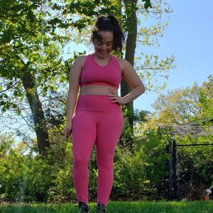 Pink matching athletic set with sports bra and leggings for pilates and cycling